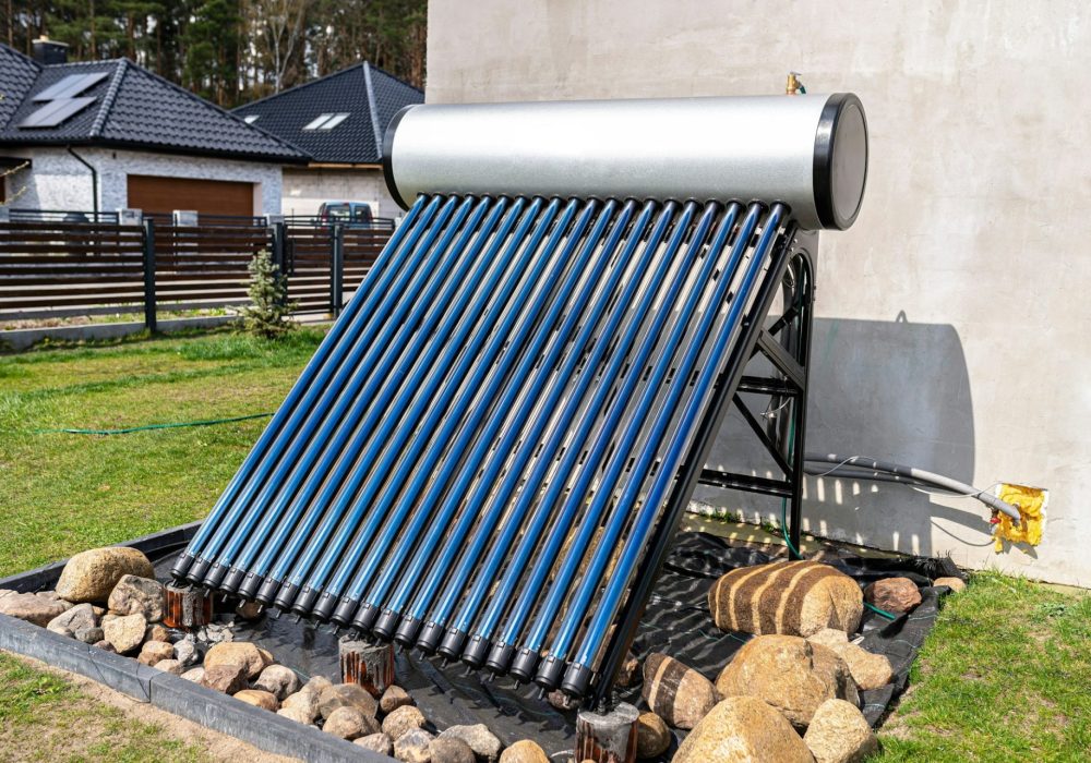 A modern solar pressure collector to heat domestic hot water, standing in front of the house