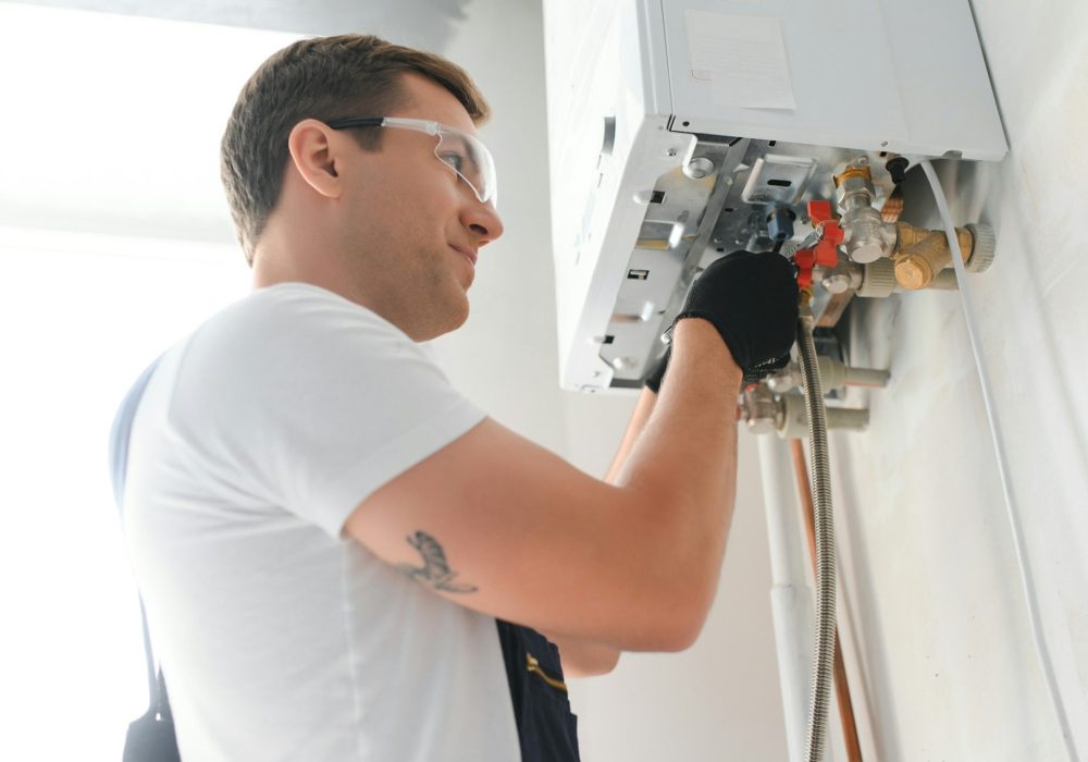 Professional boiler service: qualified technician checking a natural gas boiler at home